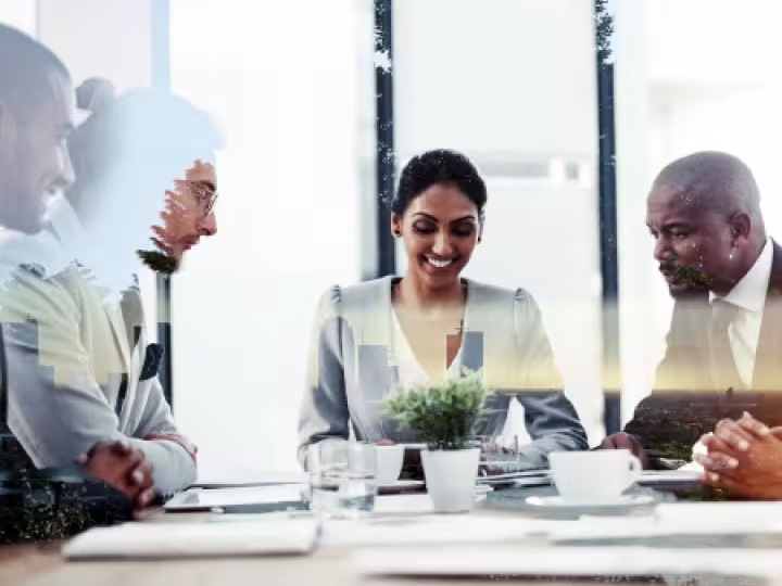 Group of people on a meeting table.