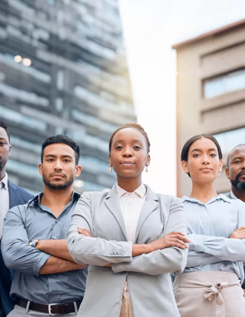 Diverse group of business professionals standing together, symbolizing inclusive leadership.